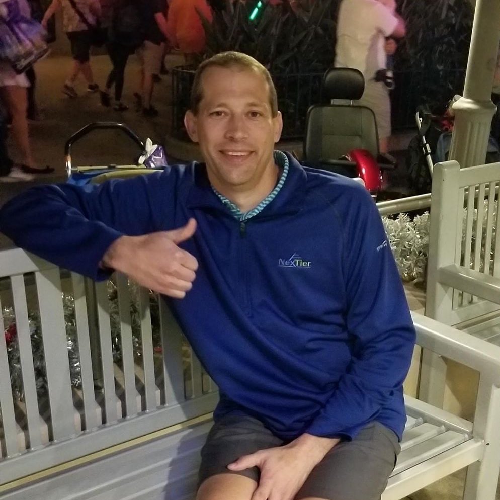 Our President & CEO, Clem Rosenberger sitting on bench at Disney World designed by our customer, Keystone Ridge Designs