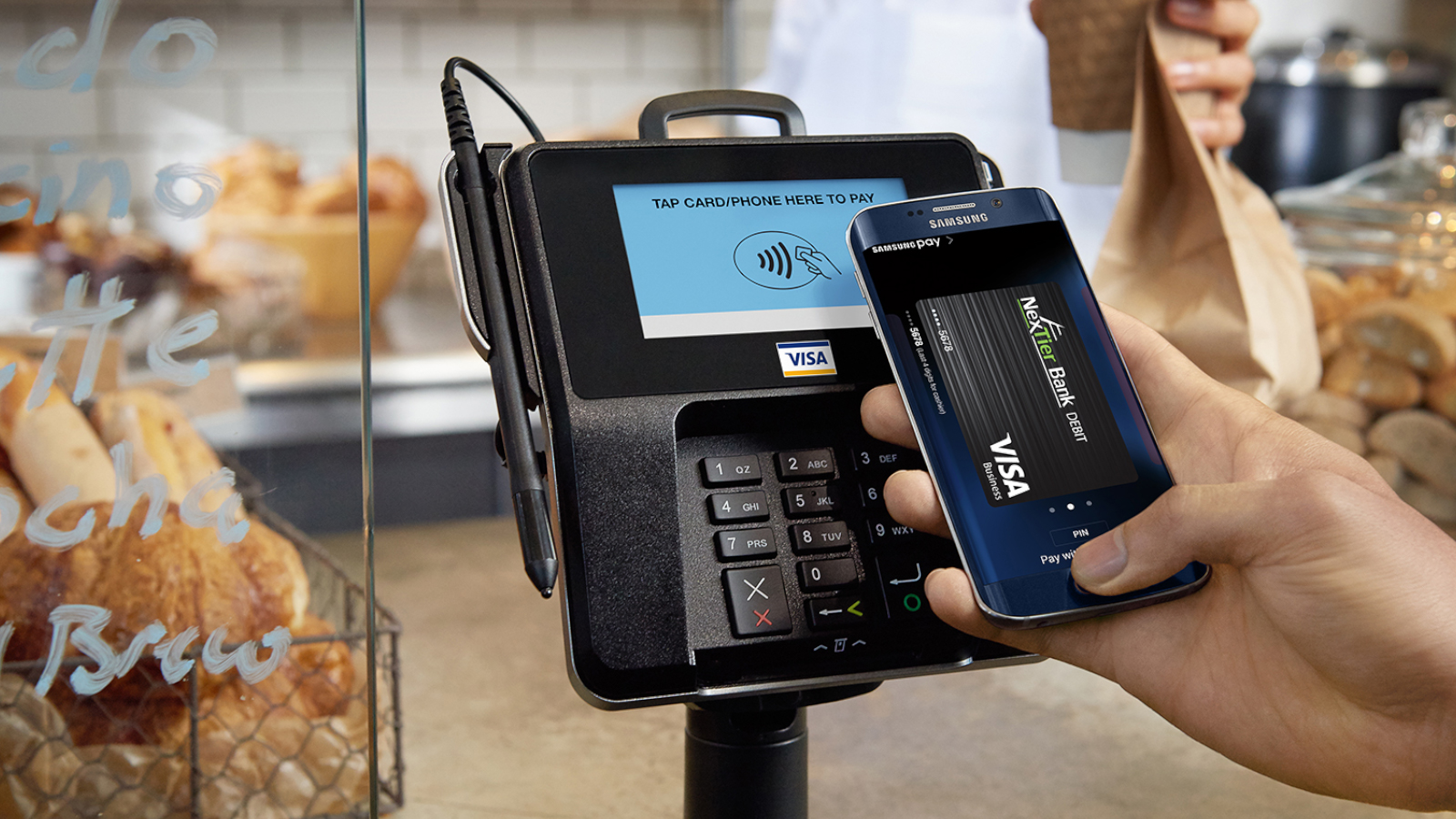 person using Samsung pay with NexTier Business Debit card
