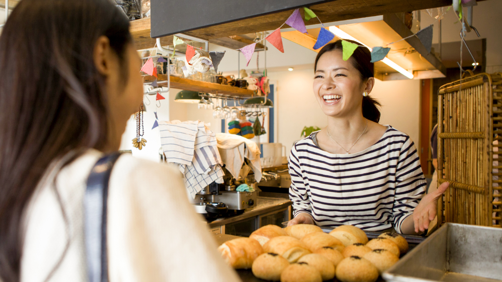 woman buying baked goods with her business debit card for her team members
