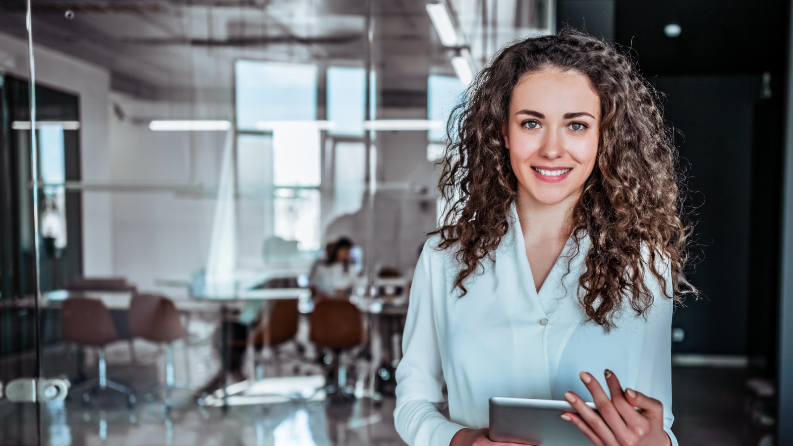 Business woman standing with tablet