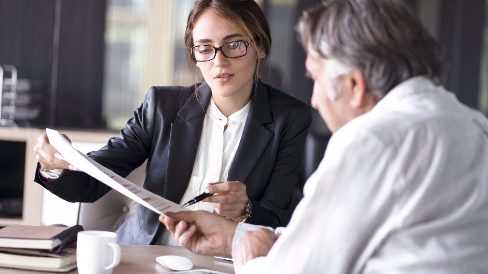 business woman showing documents to client