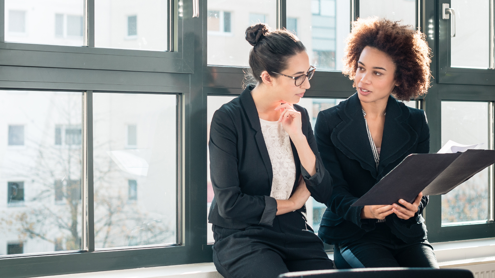 two business women discussing financials