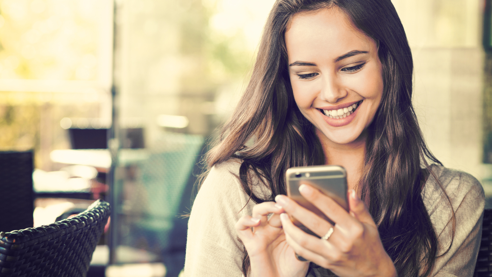 girl looking at phone screen smiling